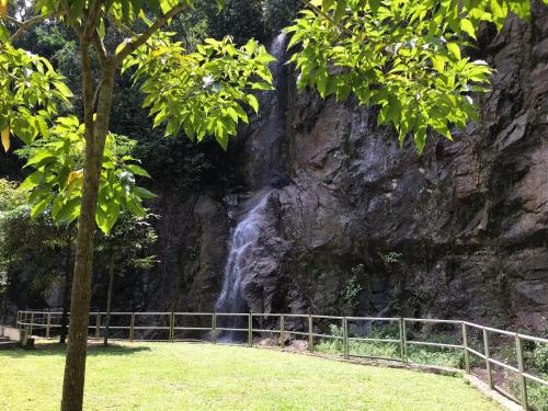 a waterfall on the side of a rock wall at Home Away From Home In Taiping - Newly Upgraded! in Taiping