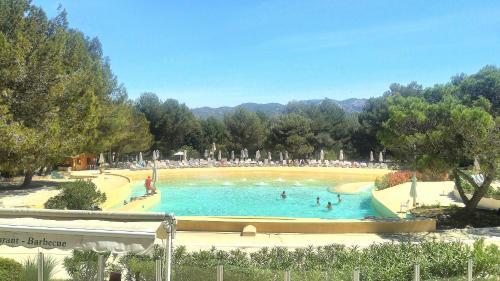 a large swimming pool with people in the water at Charmant T2 climatisé avec belle vue , Golf de Pont-Royal in Mallemort