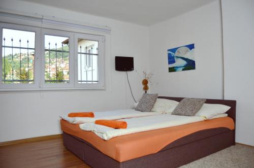 a bed sitting in a room with a window at Apartmani Balibeg in Sarajevo