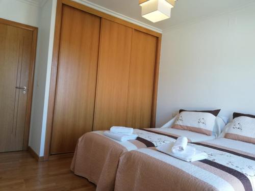 two beds sitting next to each other in a room at Pedrouzo Suites in O Pedrouzo