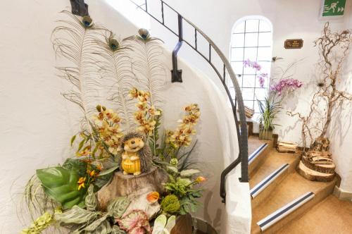 a hallway with a bunch of flowers in a building at Gasthaus Post in Muotathal