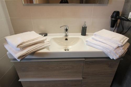 a bathroom sink with towels on top of it at "Chez Suzèle" in Gérardmer