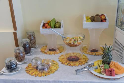 a table with fruits and other foods on it at Hotel Villa Maria in Crispiano
