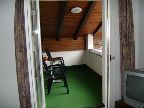 a room with a table and a chair and a television at Gasthaus Post in Muotathal