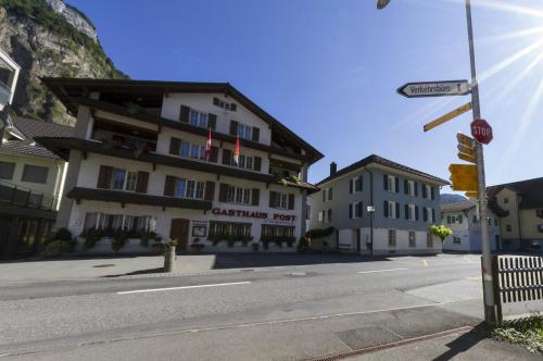 a building on the corner of a street at Gasthaus Post in Muotathal