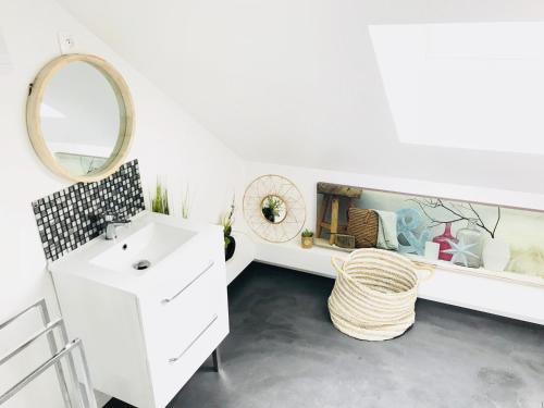 a bathroom with a white sink and a mirror at CosyStudio2 Site du Futuroscope in Jaunay-Marigny