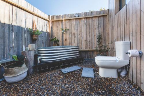 a toilet sitting in a yard next to a fence at The Farmstead in Franschhoek