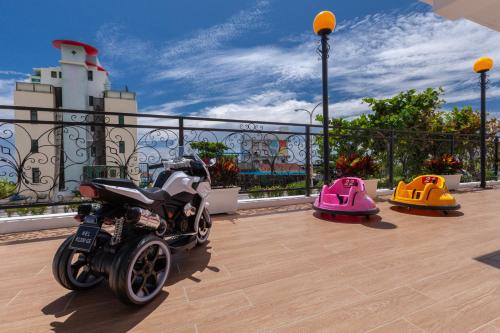 a motorcycle is parked on a balcony with some toys at Sea Dragonfly in Yanliau