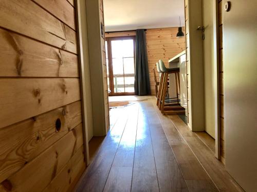 a hallway with a wooden wall and a wooden floor at Chalet de charme, le "Caribou Lodge", Eifel belge in Bullange