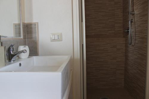 a bathroom with a sink and a shower at B&B S'arenada in Ghilarza