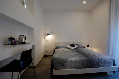 a bedroom with a bed in a white room at Galleria 38 in La Spezia