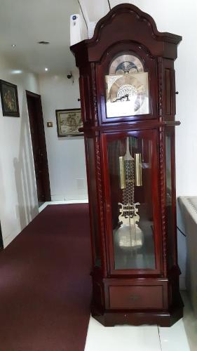 a large wooden grandfather clock in a room at Grand View Residency Chennai in Chennai