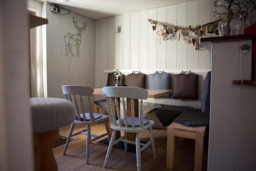 a room with a table and chairs and a couch at Bed & Breakfast Jungholz - Pension Katharina in Jungholz