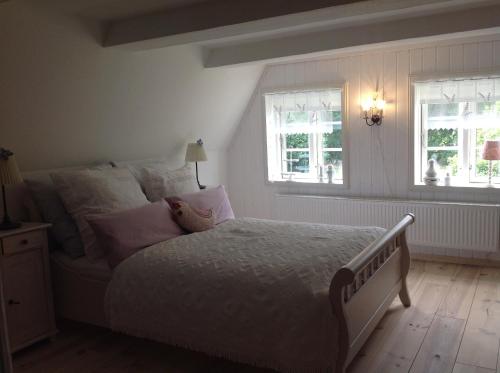 - une chambre avec un lit et 2 fenêtres dans l'établissement Separate Gästewohnung, à Plockhorst