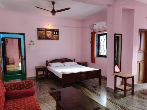a bedroom with a bed and a couch in it at Morjim Sunset Hotel in Morjim