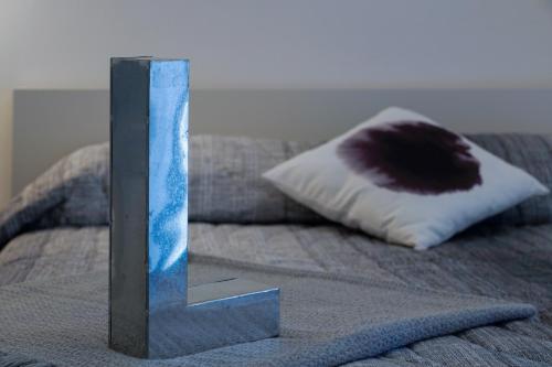 a sculpture on top of a bed with a pillow at Galleria 38 in La Spezia