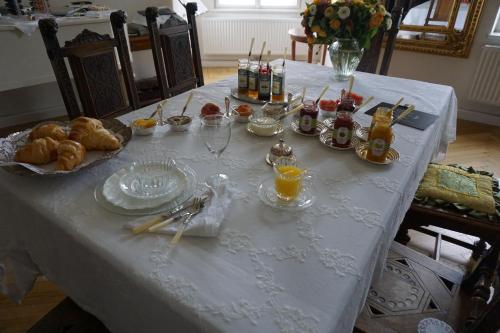 a white table with food and drinks on it at Sarah's Altstadt Oase Salzburg in Salzburg