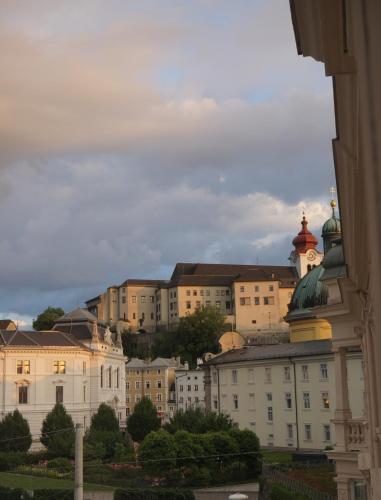 a building with a clock tower on top of it at Sarah's Altstadt Oase Salzburg in Salzburg