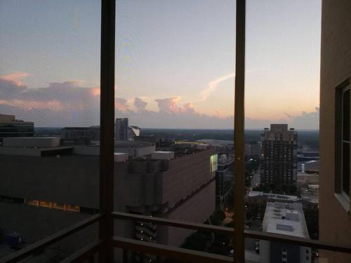 a view of a city skyline from a window at Blue Penthouse in the City in Atlanta