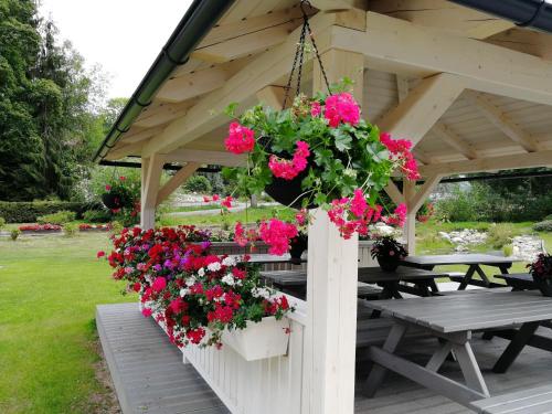 a gazebo with flowers hanging from it at Penzion Bílá voda in Harrachov