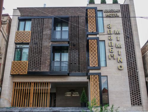 a building with a hotel sign on the side of it at Boutique Hotel Mimino in Tbilisi City