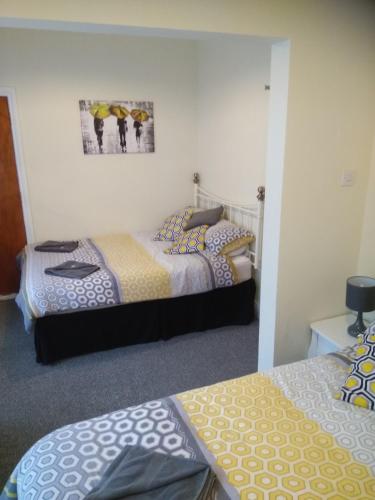 a room with two beds and a picture on the wall at The Castleton in Blackpool