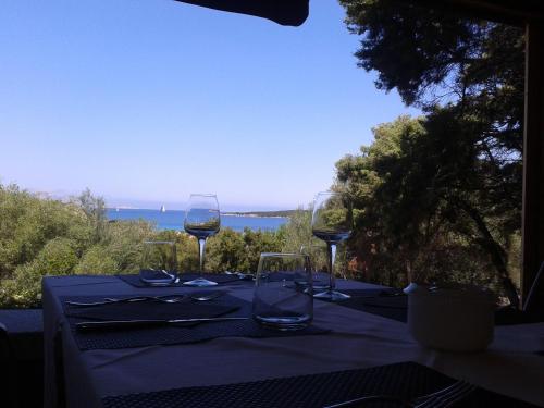 a view from the balcony of a restaurant with a view of the ocean at Bagaglino I Giardini Di Porto Cervo in Porto Cervo
