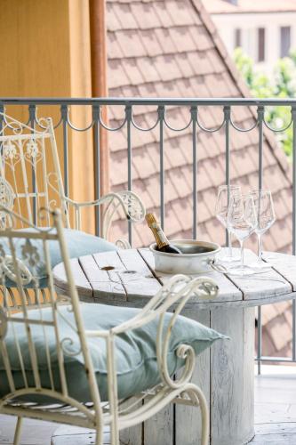 a table with wine glasses and a bowl on a balcony at Residenza La Zagara in Cannero Riviera