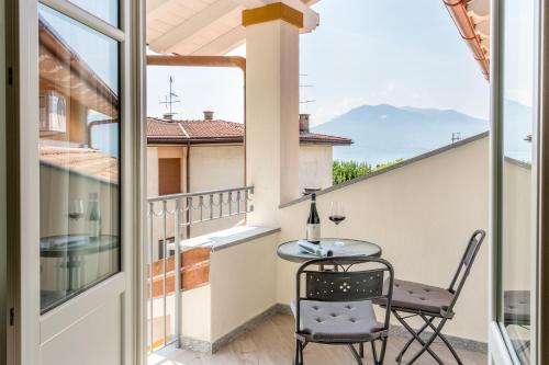 a balcony with a table and chairs and a view at Residenza La Zagara in Cannero Riviera