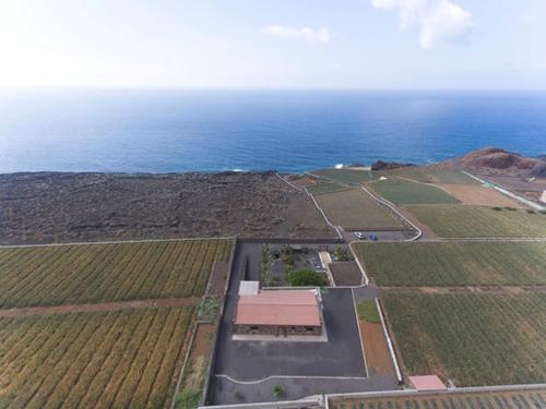 an aerial view of a field with the ocean at Villa Tejeguate in Frontera