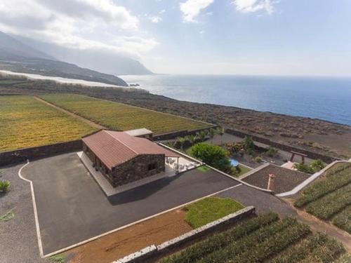 an aerial view of a building next to the ocean at Villa Tejeguate in Frontera