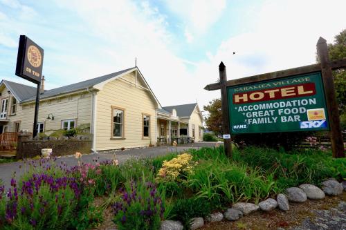 una señal de hotel frente a un edificio en Karamea Village Hotel, en Karamea