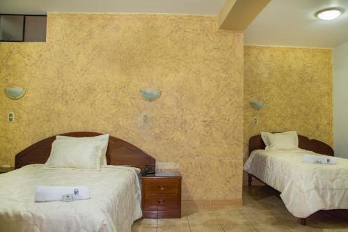 a hotel room with two beds at Hotel Villa Rita Chiclayo in Chiclayo