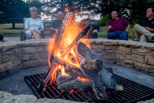 a group of people sitting around a fire pit at Spring Valley Inn in Spring Green