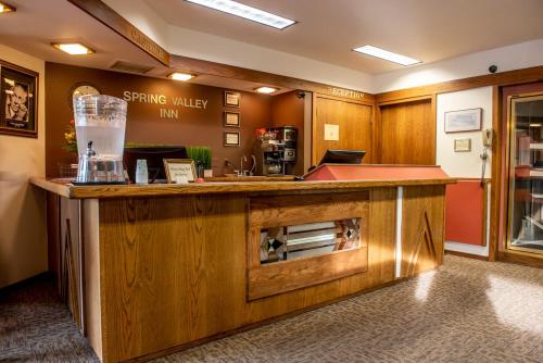 a kitchen with a large wooden island in a room at Spring Valley Inn in Spring Green