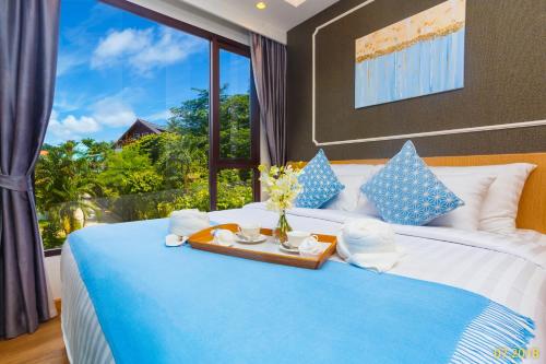 a bedroom with a bed with a large window at The Aristo Beach by Holy Cow, studio, without kitchen, mountain view in Surin Beach