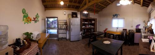 a living room with a refrigerator and a table at Sky Gift Traditional Farm B&B in Dongshi