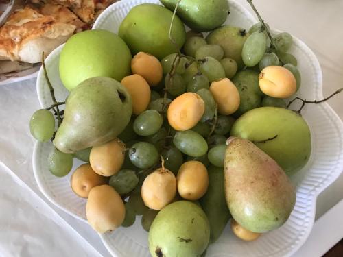 a plate full of fruit on a table at Al Bishara Guest House in Nazareth