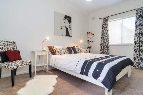 A bed or beds in a room at Stylish North Adelaide Apartments
