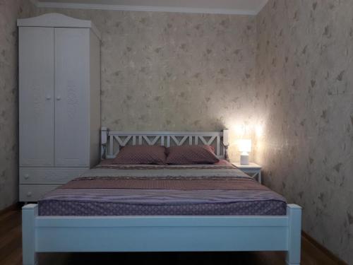チェルニーヒウにあるАпартаменты в центреのベッドルーム1室(ベッド1台、白いキャビネット付)