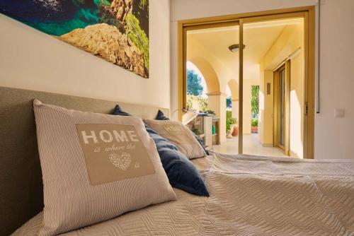 a bedroom with a bed with a home sign on it at Residence Velas Garden Pool Suite in S'Agaro