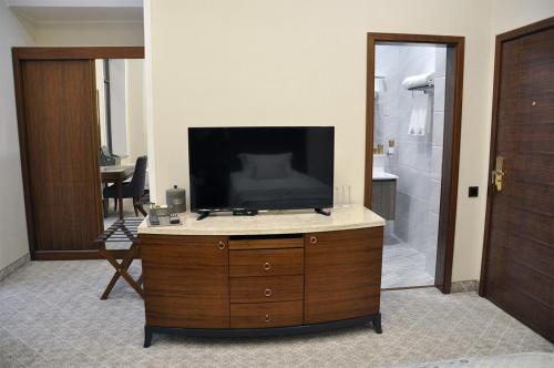 a television on top of a dresser in a bathroom at Parliament Palace Hotel in Khujand