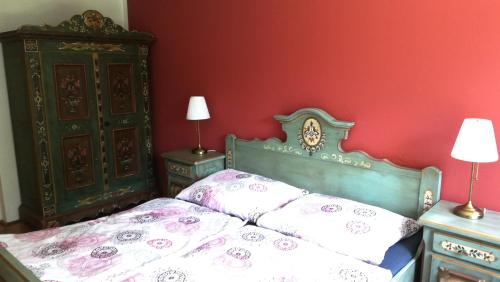 a bedroom with a bed and two night stands at Ferienhaus am Waldrand in Ampflwang im Hausruckwald