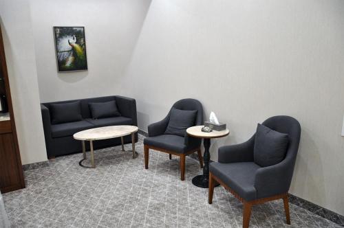 a waiting room with two chairs and a table at Parliament Palace Hotel in Khujand