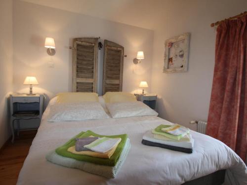 a bedroom with a bed with towels on it at La grange au tracteur in Saulcy-sur-Meurthe