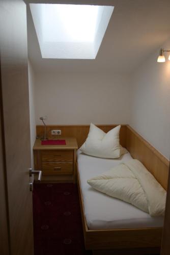 a bedroom with a bed with a skylight above it at Apart Felsenhof in Längenfeld