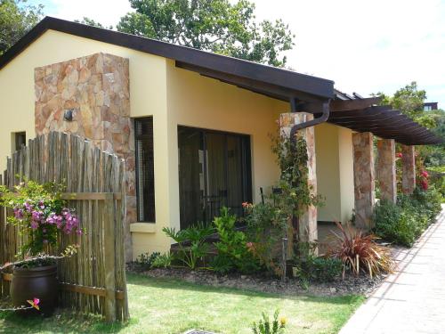 a small house with a fence in front of it at Double Dutch B & B in Knysna