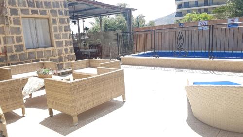 a patio with chairs and a pool on a building at Lake Mansion in Tiberias