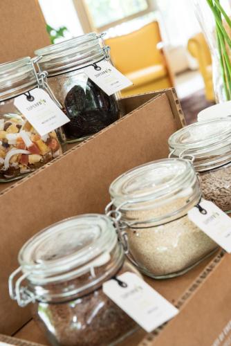 a box filled with jars of food on a table at Bio Boutique Hotel XU' - Gruppo Ambienthotels in Rimini