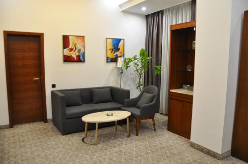 a living room with a couch and a table at Parliament Palace Hotel in Khujand
